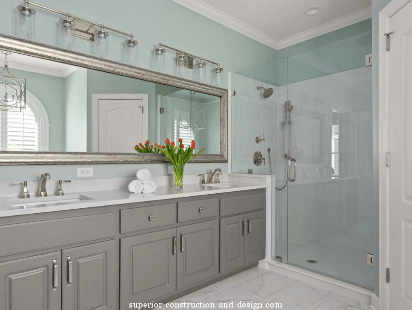 built-in vanity walk-in shower silver mirror light blue-green walls modern transitional style