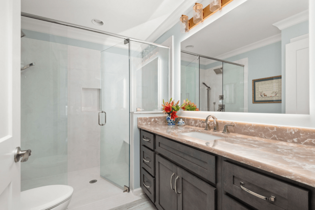 bathroom design cambria quartz wood vanity brass lighting zero entry shower addition for mother