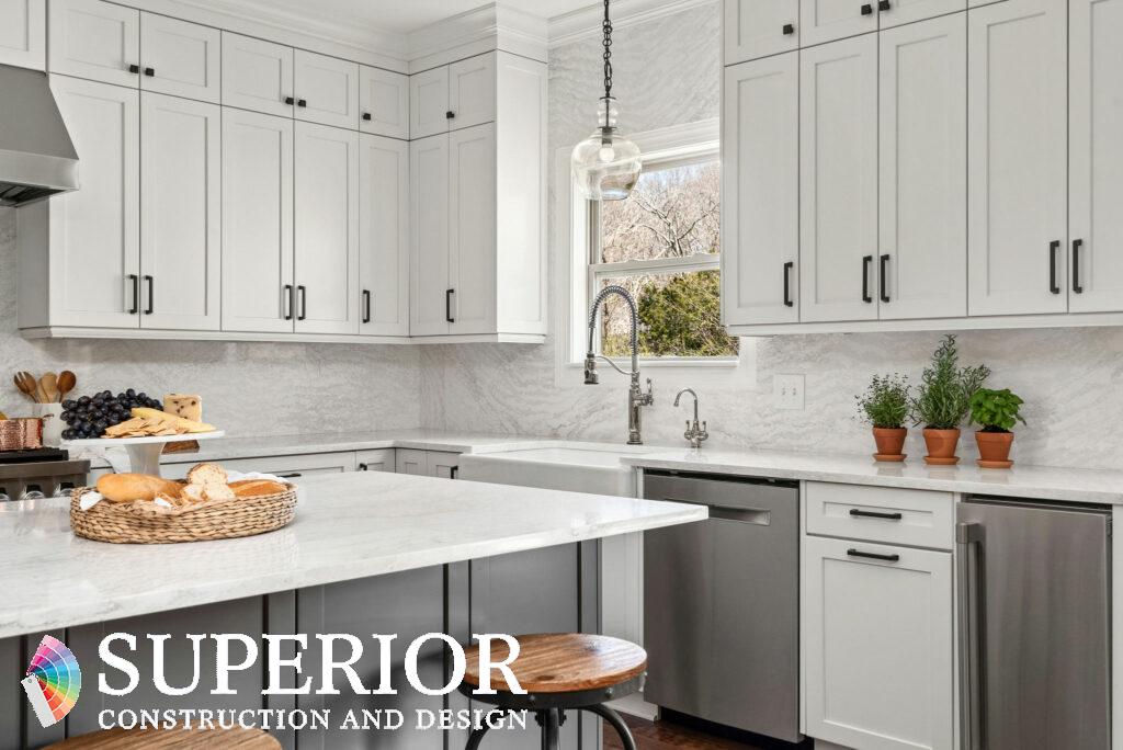 Nancy Meyers aesthetic whtie ktichen with marble, glass pendant and herbs on the countertop